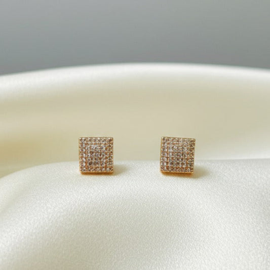 Stylish and modern, these artificial pavé square stud earrings feature a dazzling arrangement of stones that create a radiant sparkle. Their sleek square design adds a touch of sophistication, making them perfect for both casual wear and special occasions. Lightweight and elegant, these studs bring timeless charm and contemporary flair to any jewelry collection.