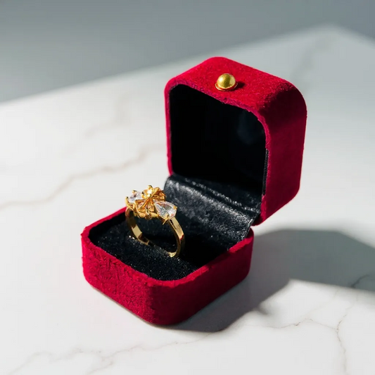 Premium ring with two diamonds and smaller stones on a reflective surface